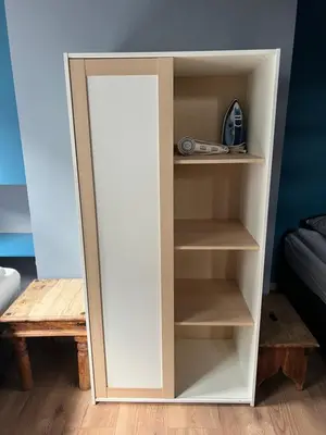 a book shelf with a mirror in a room at Nes B&B in Amsterdam