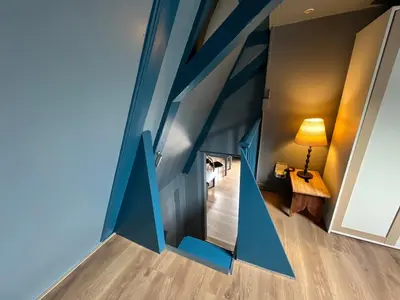 a room with blue walls and a hallway with a lamp at Nes B&B in Amsterdam