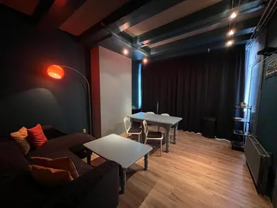 a living room with two tables and a couch at Nes B&B in Amsterdam