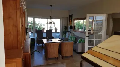a kitchen and living room with a table and chairs at Kampan in Zandvoort