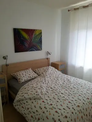 a bedroom with a bed and a painting on the wall at Kampan in Zandvoort