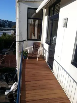 a balcony with a wooden walkway on a house at Kampan in Zandvoort