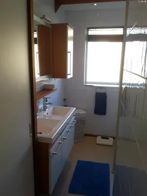 a small bathroom with a sink and a shower at Kampan in Zandvoort