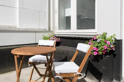 two chairs and a table in front of a window at Artis Plantage Apartment in Amsterdam