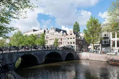 a bridge over a river with bikes on it at Artis Plantage Apartment in Amsterdam