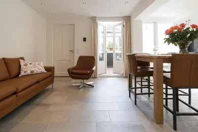 a living room with a couch and a table at Artis Plantage Apartment in Amsterdam