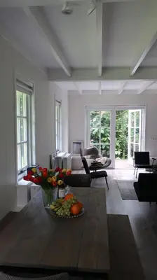 a living room with a table with a bowl of fruit at Gina's garden house in Amsterdam