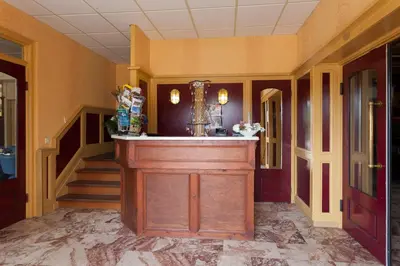 a lobby with a bar in the center of a building at De Vooroever in Wervershoof