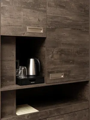 a wooden cabinet with a tea kettle in it at Hotel-Restaurant Het Rechthuis in Muiderberg