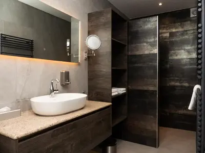 a bathroom with a sink and a mirror at Hotel-Restaurant Het Rechthuis in Muiderberg