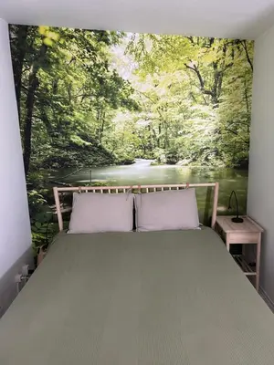 a bedroom with a painting of a river at Zen in Schoorl in Schoorl