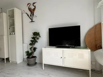 a living room with a television on a white cabinet at Zen in Schoorl in Schoorl