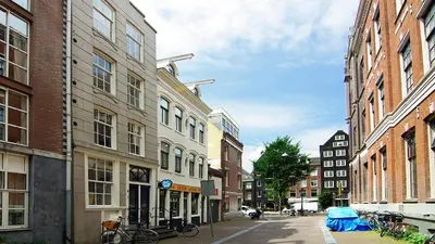 a city street with tall buildings and bikes on the street at Loft Leidsegracht in Amsterdam