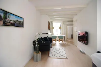 a living room with a couch and a table at Loft Leidsegracht in Amsterdam