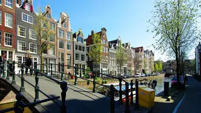 a city street with buildings and trees and a bridge at Loft Leidsegracht in Amsterdam