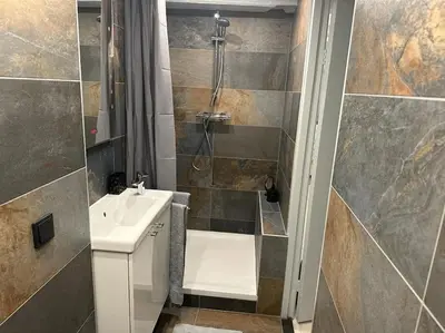 a bathroom with a sink and a shower at Unique Royal Basement residence in Amsterdam