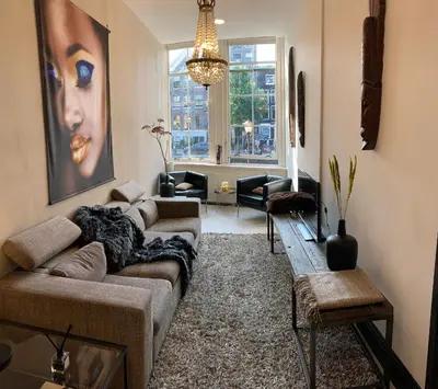 a living room with a couch and a table at Unique Royal Basement residence in Amsterdam