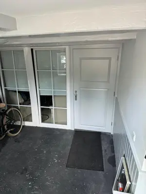 a garage with a white door and some shelves at Unique Royal Basement residence in Amsterdam