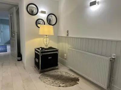 a room with a lamp and two mirrors on the wall at Unique Royal Basement residence in Amsterdam
