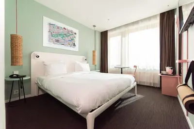 a bedroom with a large white bed in a room at Conscious Hotel Vondelpark in Amsterdam