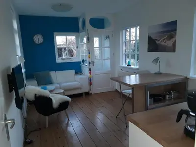 a living room with a couch and a table at de Vrijheid in Groet