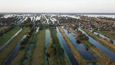 an aerial view of a river with trees at Yess in Vinkeveen