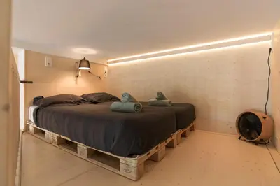 a bedroom with a bed with two stuffed animals on it at Studio Jan Steen in Amsterdam