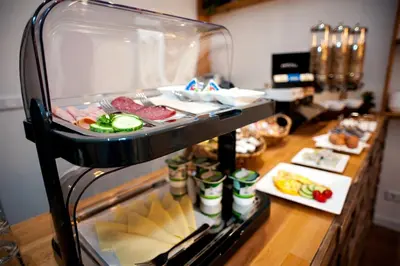 a display case with meat and vegetables on a counter at i hotel in Amsterdam