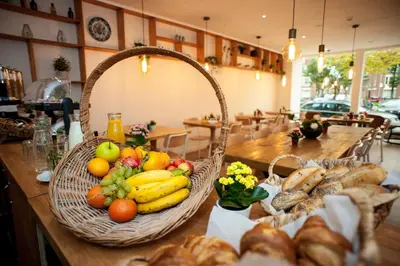 a table with baskets of fruit and bread on it at i hotel in Amsterdam