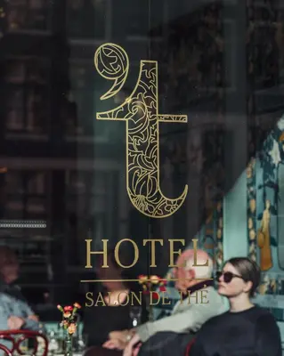 a window of a hotel with a gold sign on it at 't Hotel in Amsterdam