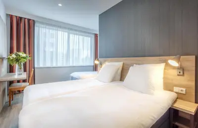 a hotel room with a large bed and a window at Joy Hotel in Amsterdam