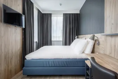 a hotel room with a bed and a desk at Joy Hotel in Amsterdam