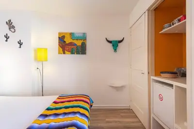 a bedroom with a bed and a cow head on the wall at B&B Little Miss Sunshine in Zandvoort