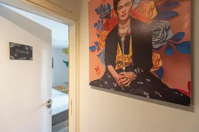 a painting of a woman on a wall in a room at B&B Little Miss Sunshine in Zandvoort