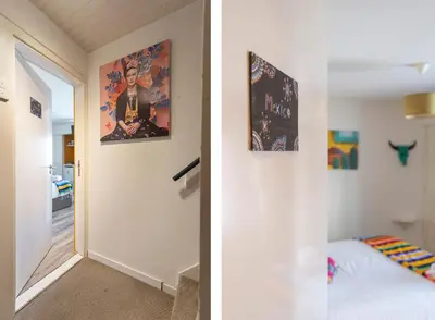 a bedroom with a bed and a painting on the wall at B&B Little Miss Sunshine in Zandvoort