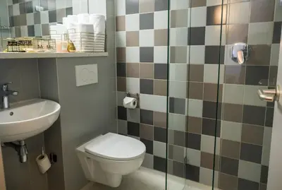 a bathroom with a toilet and a sink at Linden Hotel in Amsterdam