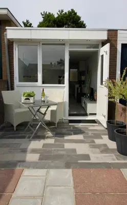a patio with a table and chairs on a patio at Casa Belle Dune in Zandvoort