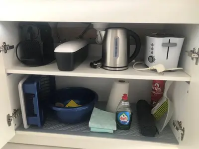 a kitchen shelf with a coffee maker and other kitchen items at Casa Belle Dune in Zandvoort