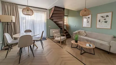 a living room with a couch and a table at Strandstudio's Camperduin in Schoorl