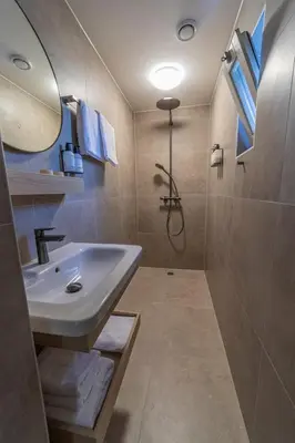 a bathroom with a sink and a shower at Strandstudio's Camperduin in Schoorl