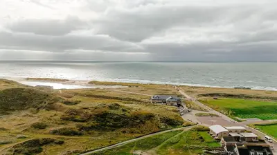 an aerial view of a beach and the ocean at Strandstudio's Camperduin in Schoorl