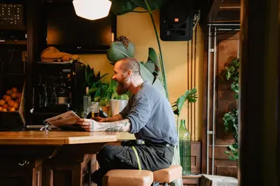 a man sitting at a table in a bar at Long John's Pub & Hotel in Amersfoort