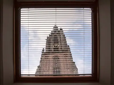 a window with a view of a clock tower at Long John's Pub & Hotel in Amersfoort