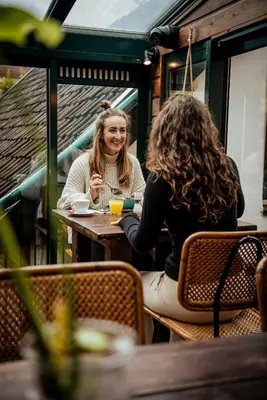 two women sitting at a table in a restaurant at Long John's Pub & Hotel in Amersfoort