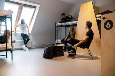 a group of people in a room with bunk beds at Via Amsterdam in Amsterdam