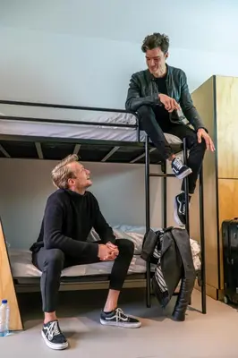 two men sitting on top of a bunk bed at Via Amsterdam in Amsterdam