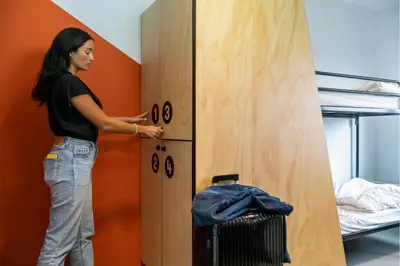 a woman standing in front of a locker room at Via Amsterdam in Amsterdam