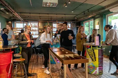 a group of people standing in a bar at Via Amsterdam in Amsterdam