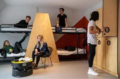 a group of people in a room with bunk beds at Via Amsterdam in Amsterdam