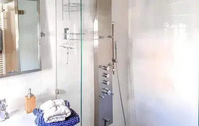 a bathroom with a shower with a glass door at Het Edamse Vissershuisje in Edam